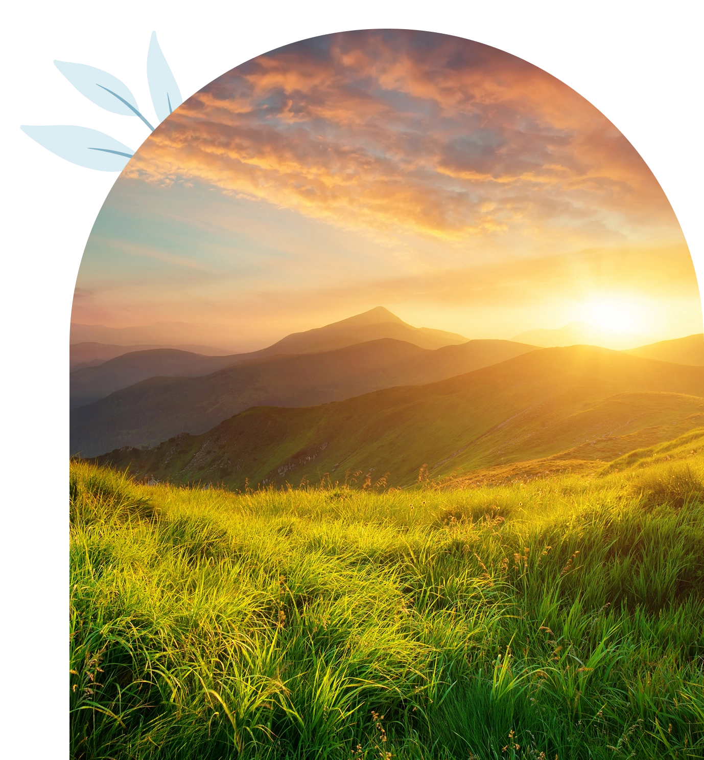 Sunrise over grassy hills and mountains.
